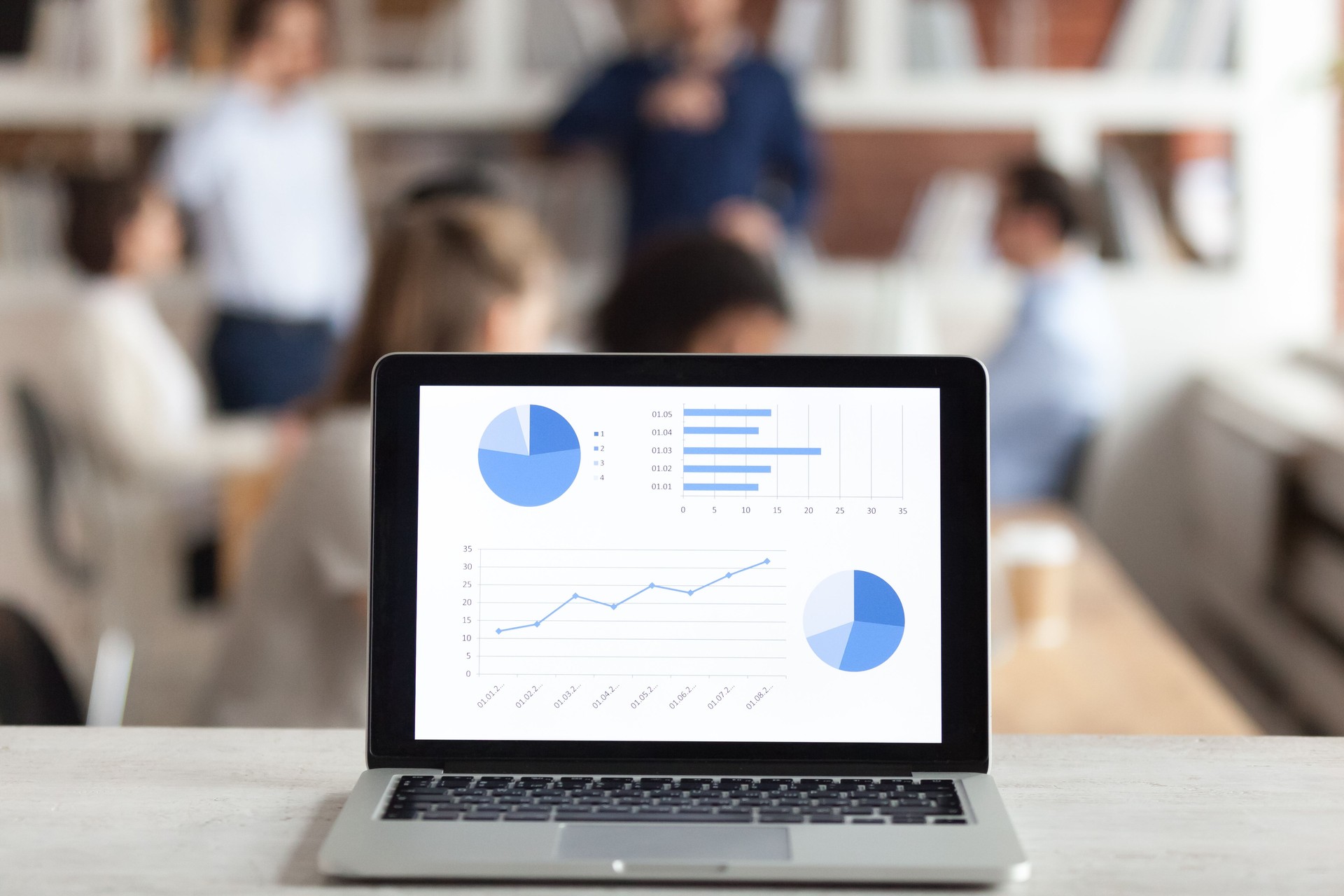 Laptop with financial charts and graph on screen